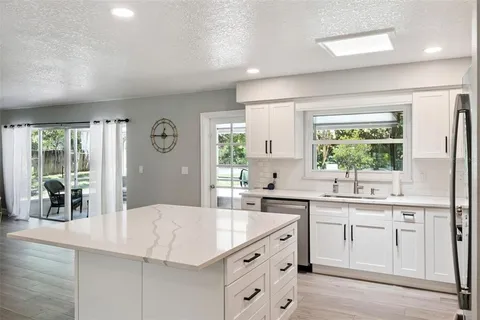 a kitchen with a sink stove and cabinets