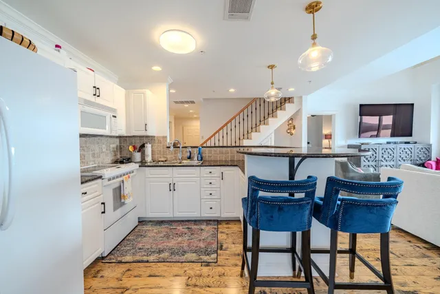 a kitchen with granite countertop a sink and cabinets