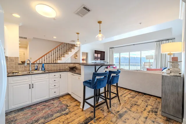 a large room with kitchen island granite countertop a large window