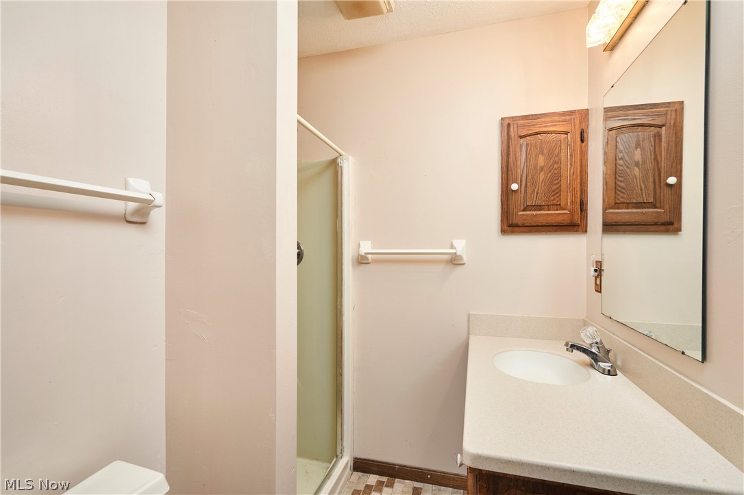 3097 Baughman Road Clinton, OH 44216 - Photo 15 of 27 Bathroom vanity featuring a single sink, chrome faucet, and integrated countertop