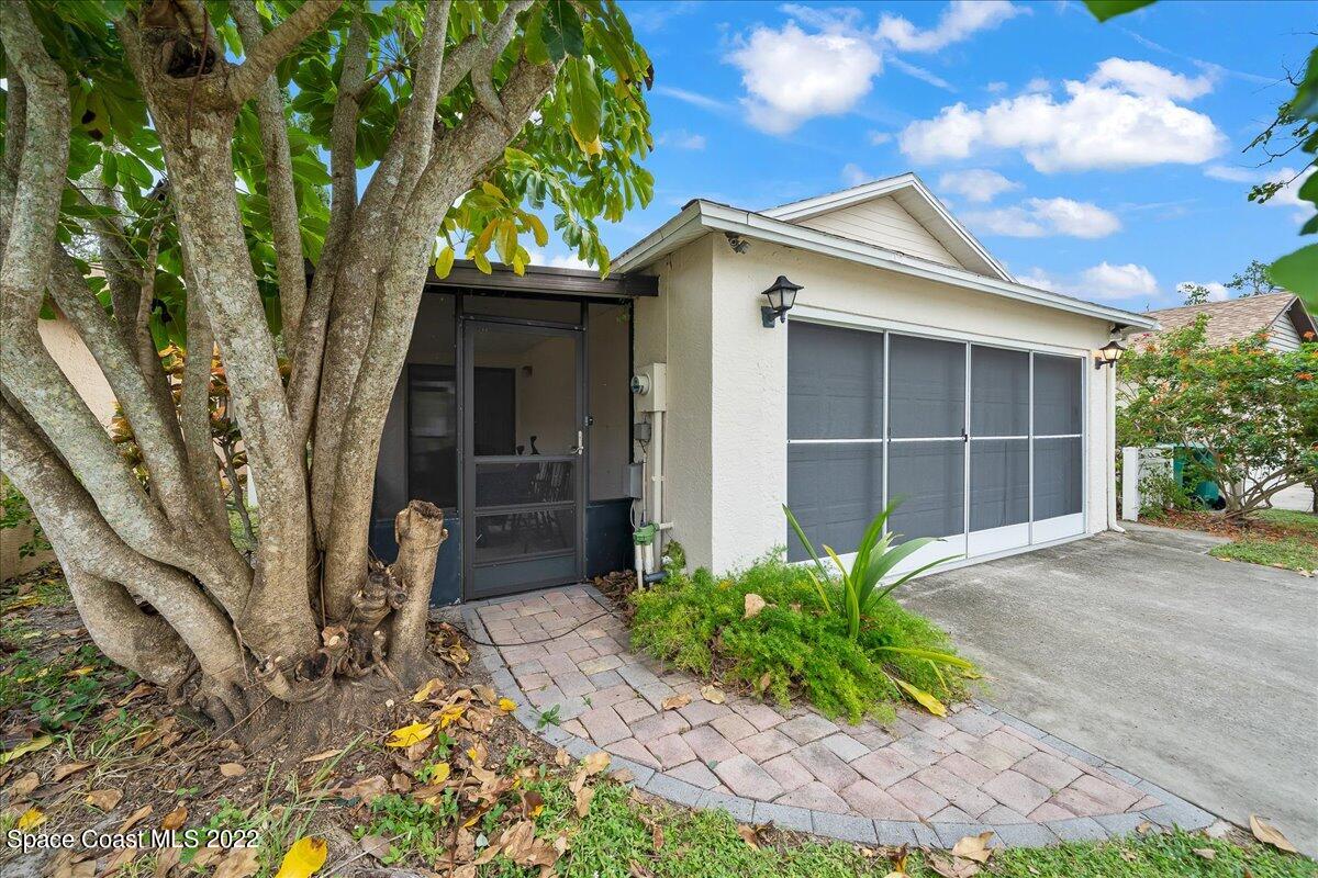 3709 Tree Line Boulevard Melbourne, FL 32935 - Photo 1 of 22 a front view of a house with a yard and garage