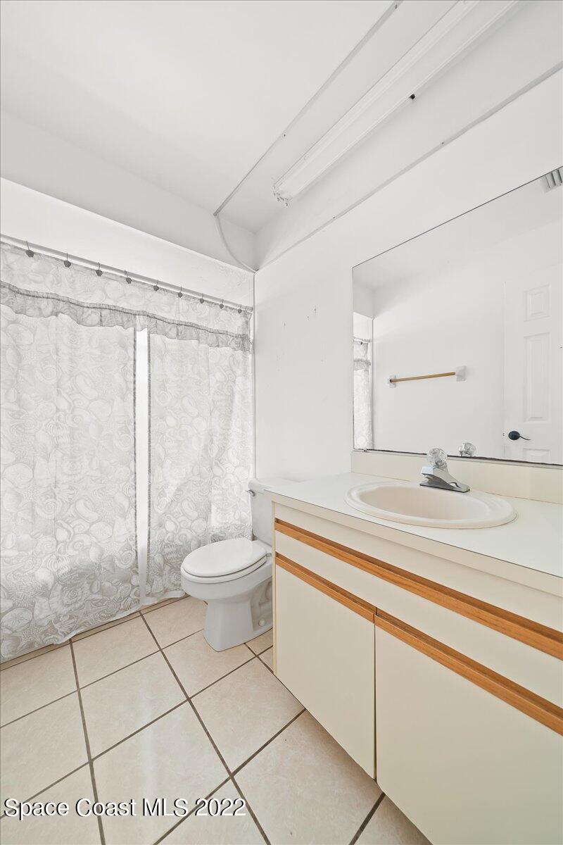 3709 Tree Line Boulevard Melbourne, FL 32935 - Photo 11 of 22 a bathroom with a toilet a sink and a shower