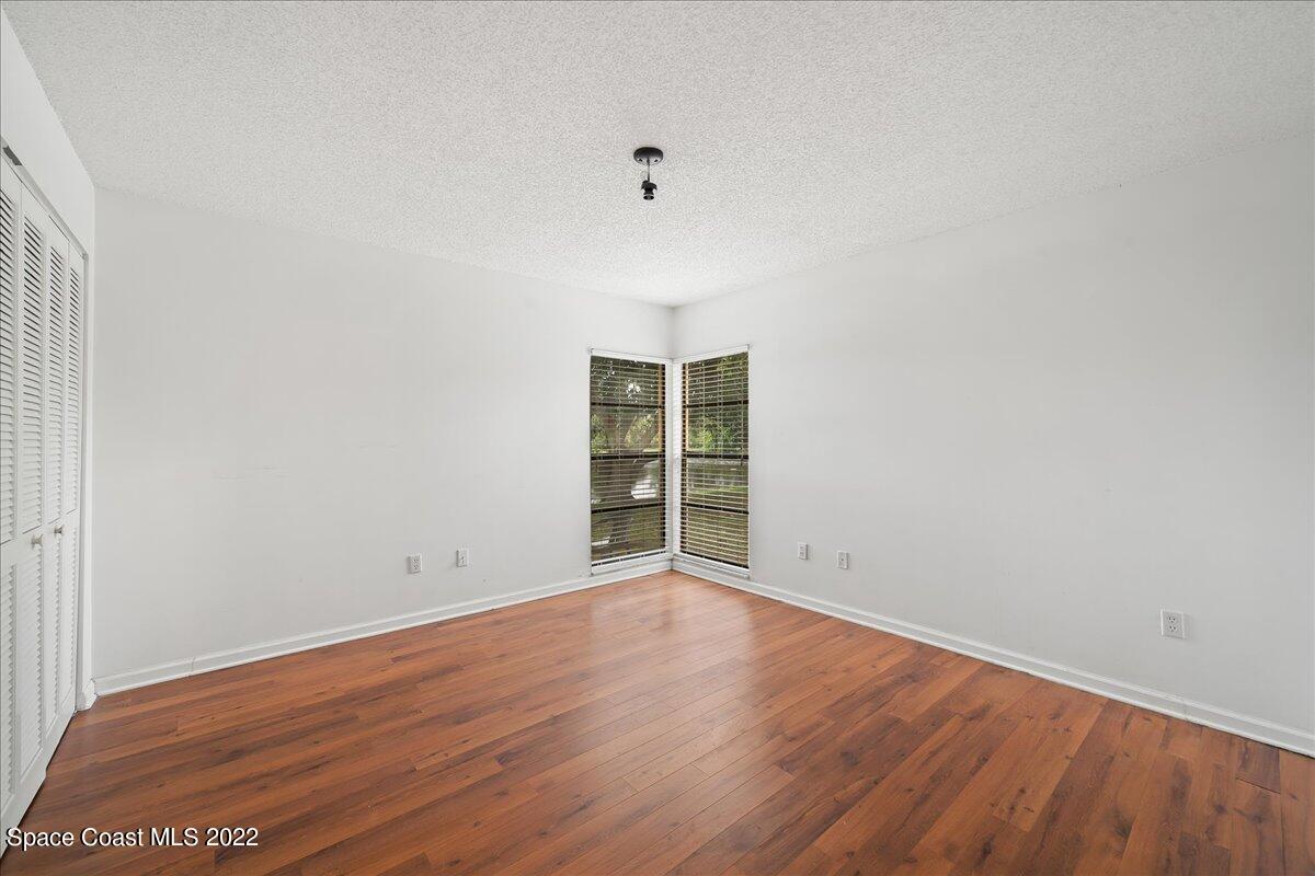 3709 Tree Line Boulevard Melbourne, FL 32935 - Photo 12 of 22 a view of an empty room with wooden floor and a window