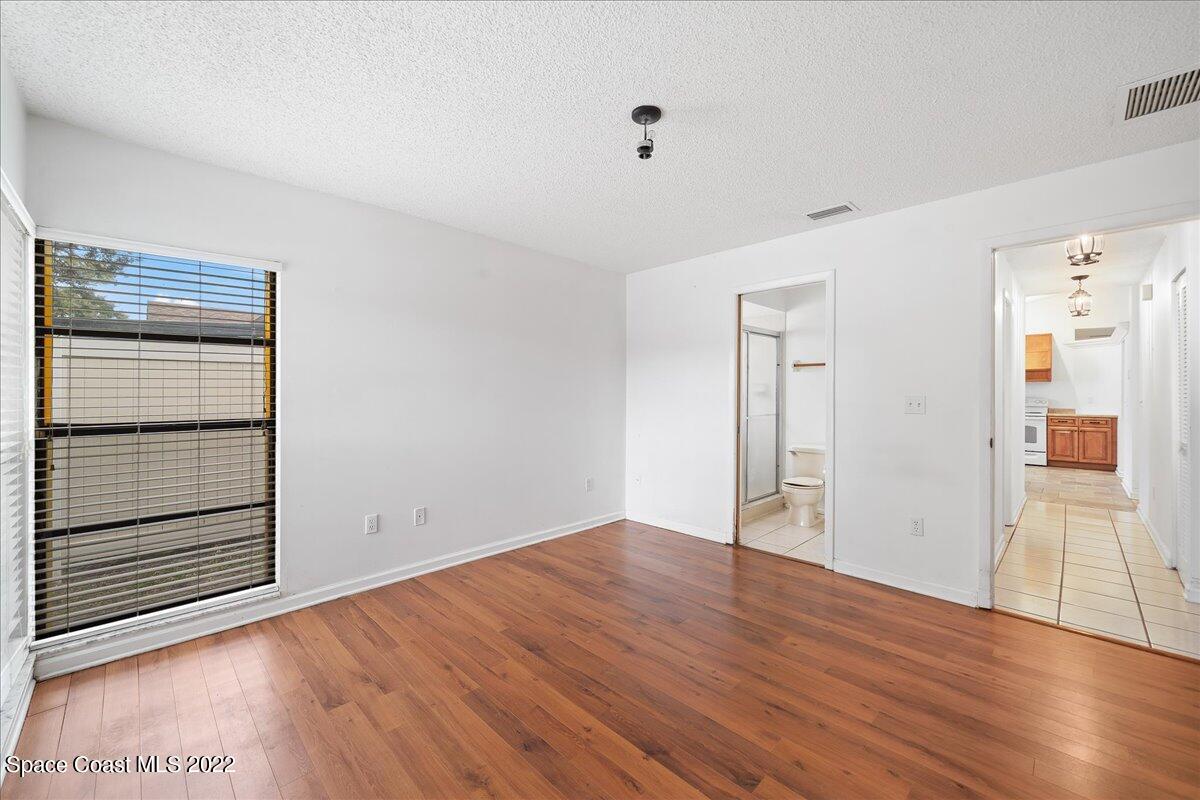 3709 Tree Line Boulevard Melbourne, FL 32935 - Photo 13 of 22 a view of empty room with wooden floor