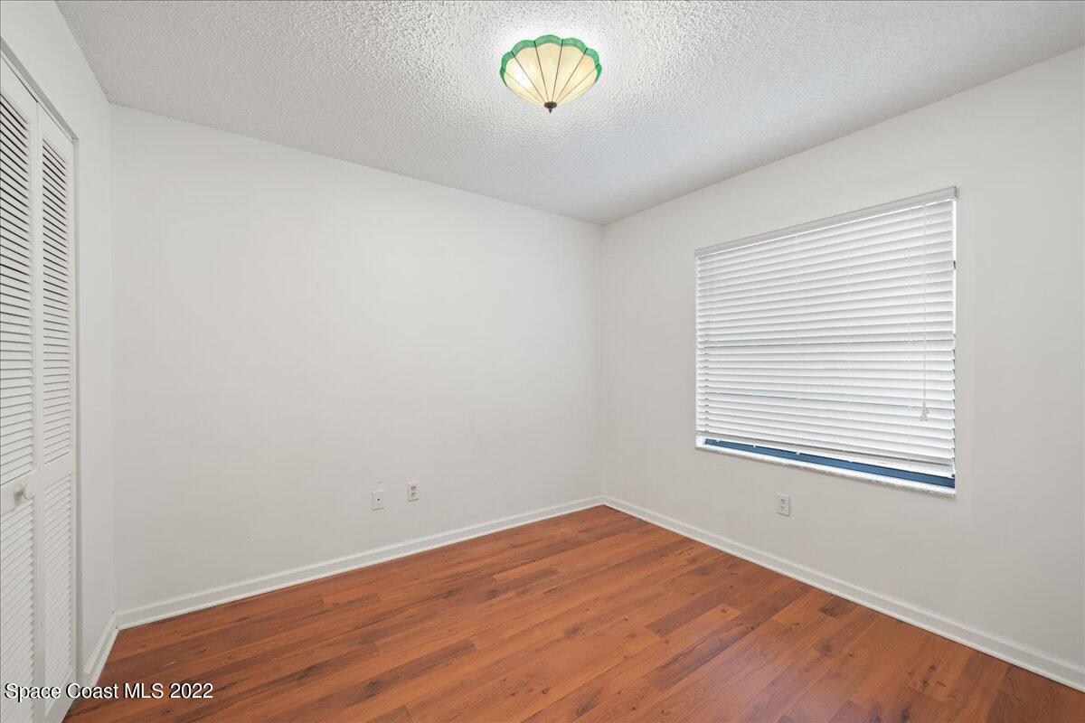 3709 Tree Line Boulevard Melbourne, FL 32935 - Photo 16 of 22 a view of empty room with window and wooden floor
