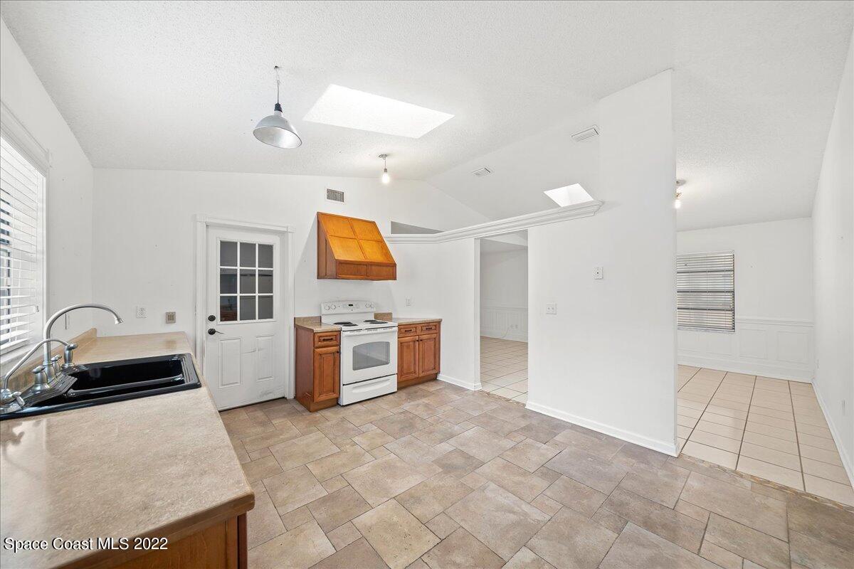 3709 Tree Line Boulevard Melbourne, FL 32935 - Photo 4 of 22 a kitchen with granite countertop a sink and a stove top oven