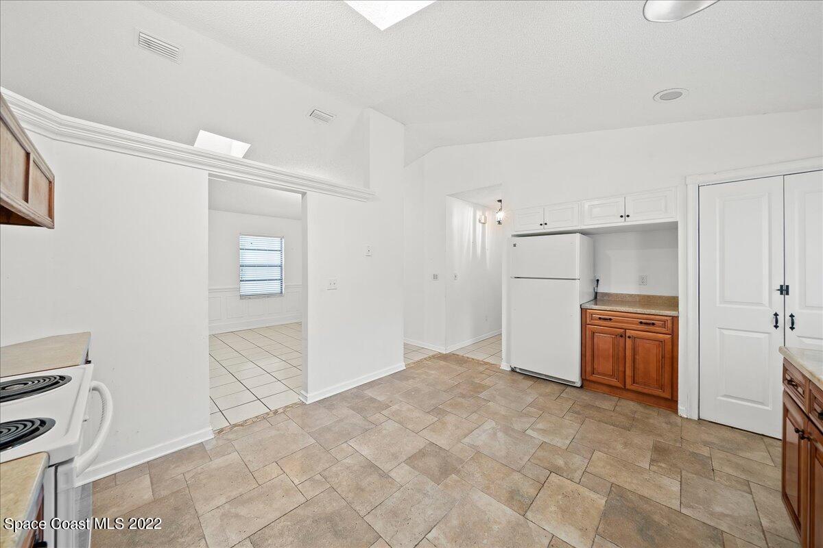 3709 Tree Line Boulevard Melbourne, FL 32935 - Photo 7 of 22 a view of a kitchen with a sink and dishwasher refrigerator stove