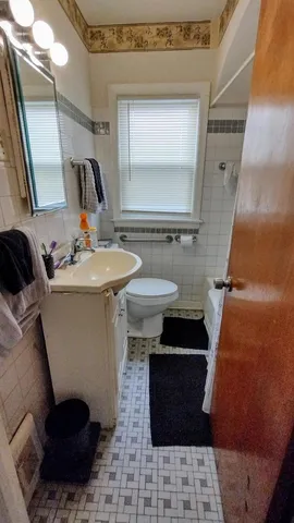 a bathroom with a sink a toilet and mirror