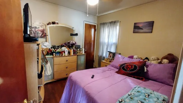 a bedroom with a bed and a dresser