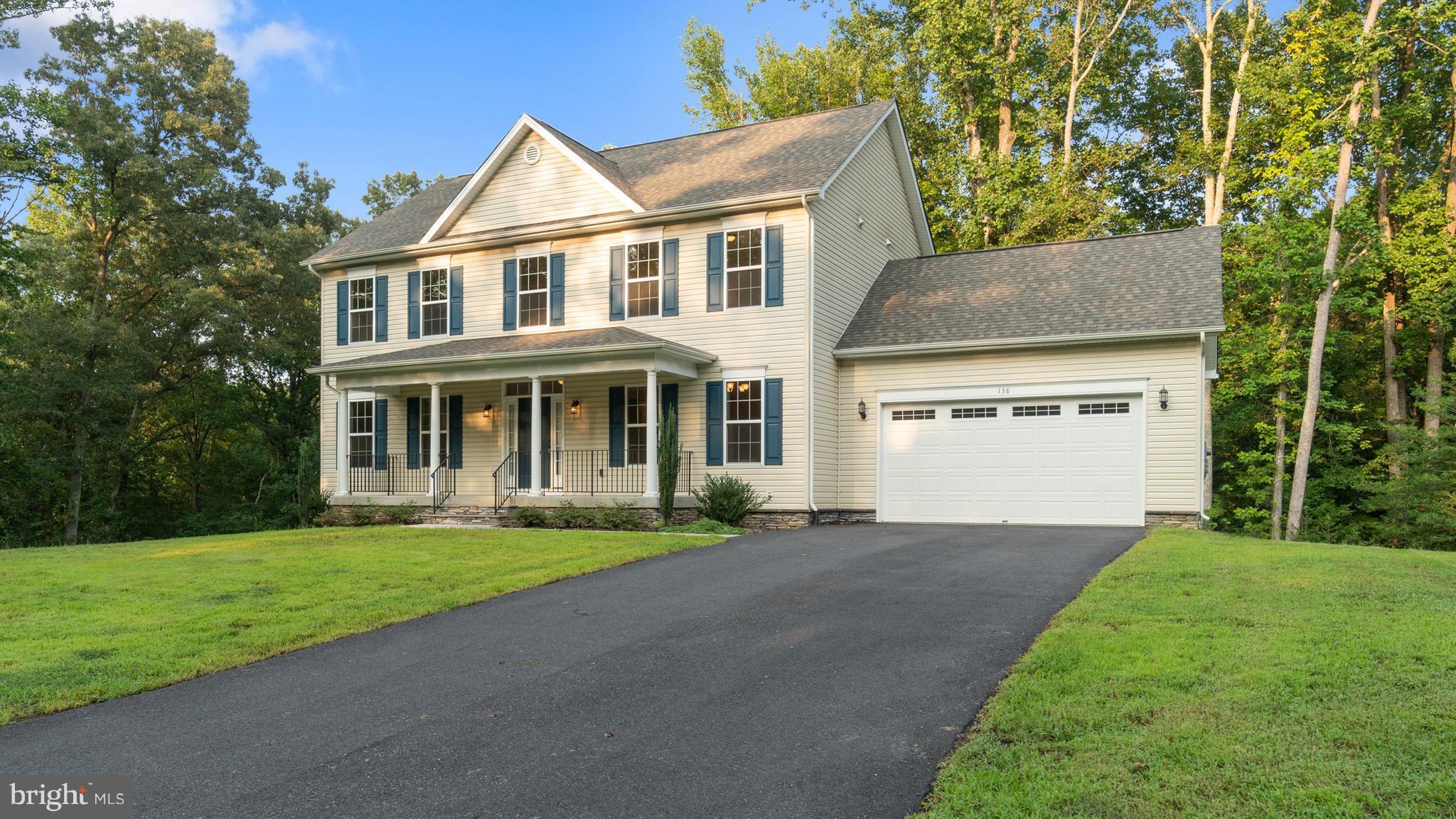 138 Sandy Ridge Road Fredericksburg, VA 22405 - Photo 1 of 30 a front view of a house with a yard and garage