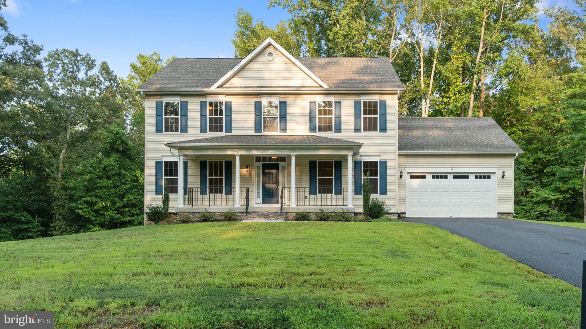 138 Sandy Ridge Road Fredericksburg, VA 22405 - Photo 16 of 30 a front view of a house with yard and green space