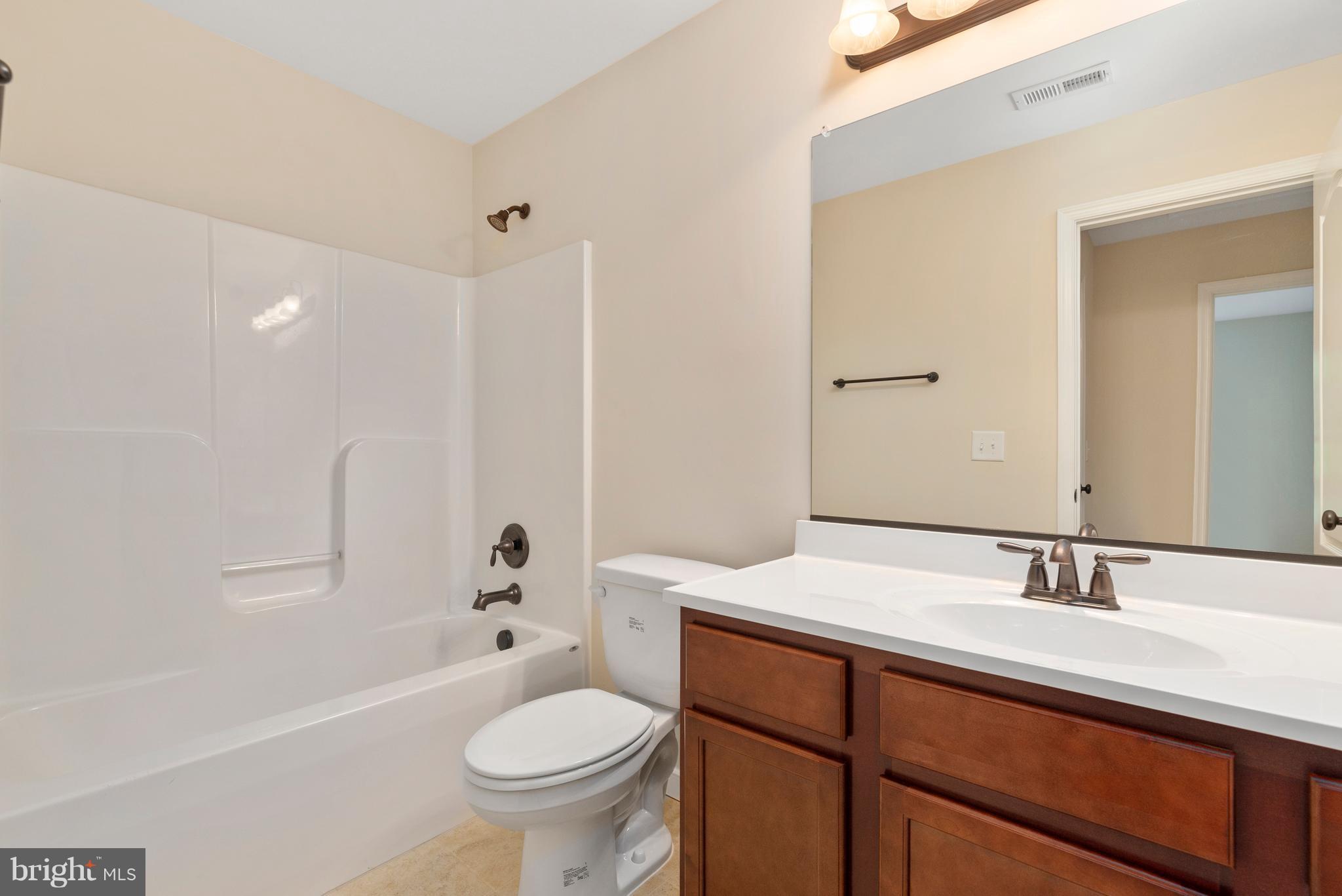 138 Sandy Ridge Road Fredericksburg, VA 22405 - Photo 18 of 30 a bathroom with a sink a toilet and a mirror