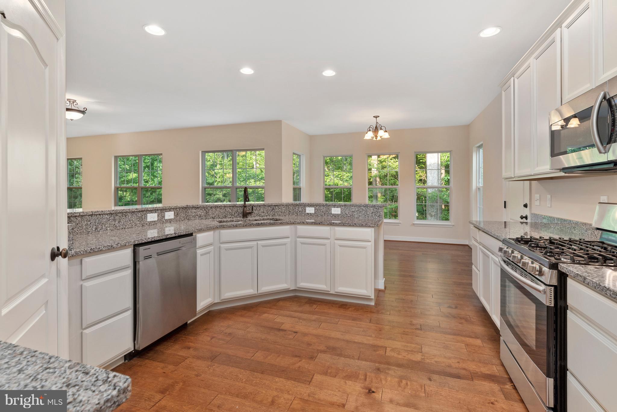 138 Sandy Ridge Road Fredericksburg, VA 22405 - Photo 2 of 30 a kitchen with stainless steel appliances granite countertop a stove a sink and a microwave