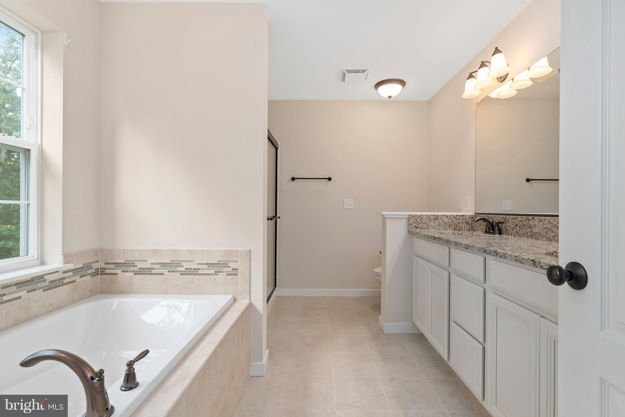 138 Sandy Ridge Road Fredericksburg, VA 22405 - Photo 23 of 30 a bathroom with a tub sink and mirror