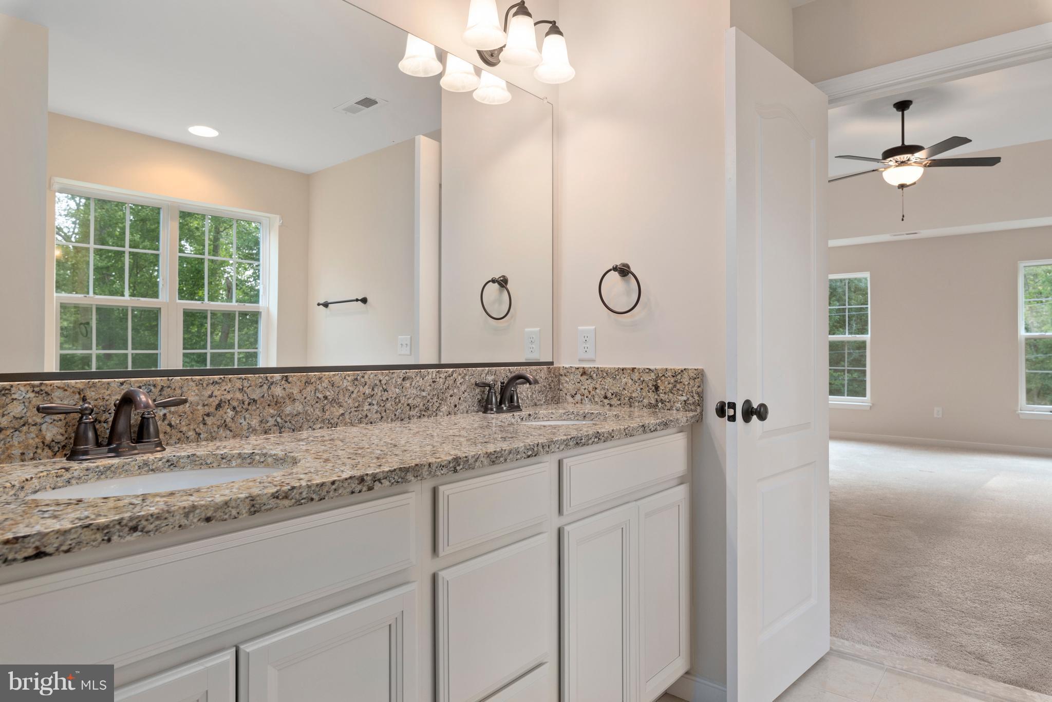 138 Sandy Ridge Road Fredericksburg, VA 22405 - Photo 25 of 30 a bathroom with a sink vanity granite and a mirror