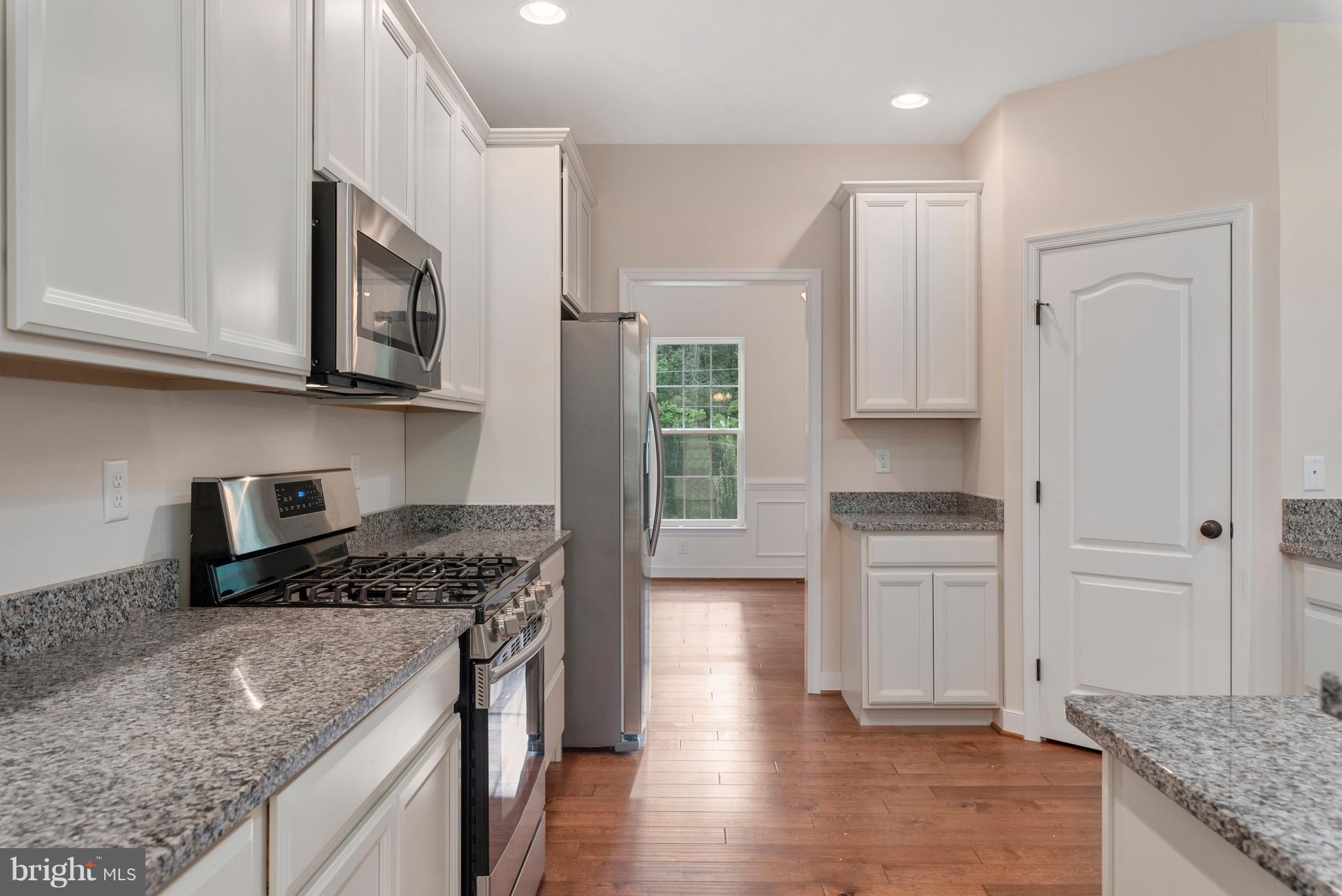 138 Sandy Ridge Road Fredericksburg, VA 22405 - Photo 3 of 30 a kitchen with granite countertop a sink a stove and cabinets