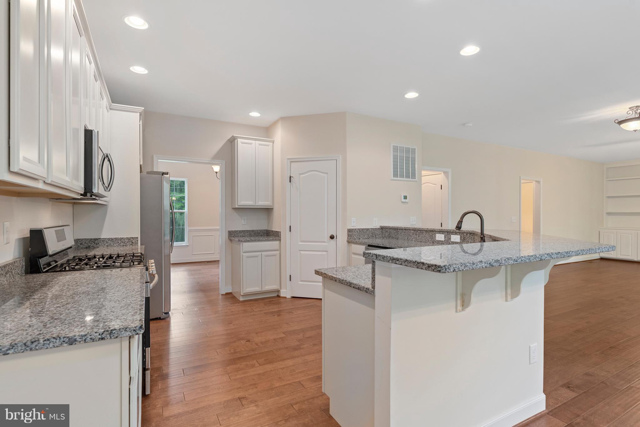 138 Sandy Ridge Road Fredericksburg, VA 22405 - Photo 7 of 30 a kitchen with stainless steel appliances granite countertop a sink stove and cabinets