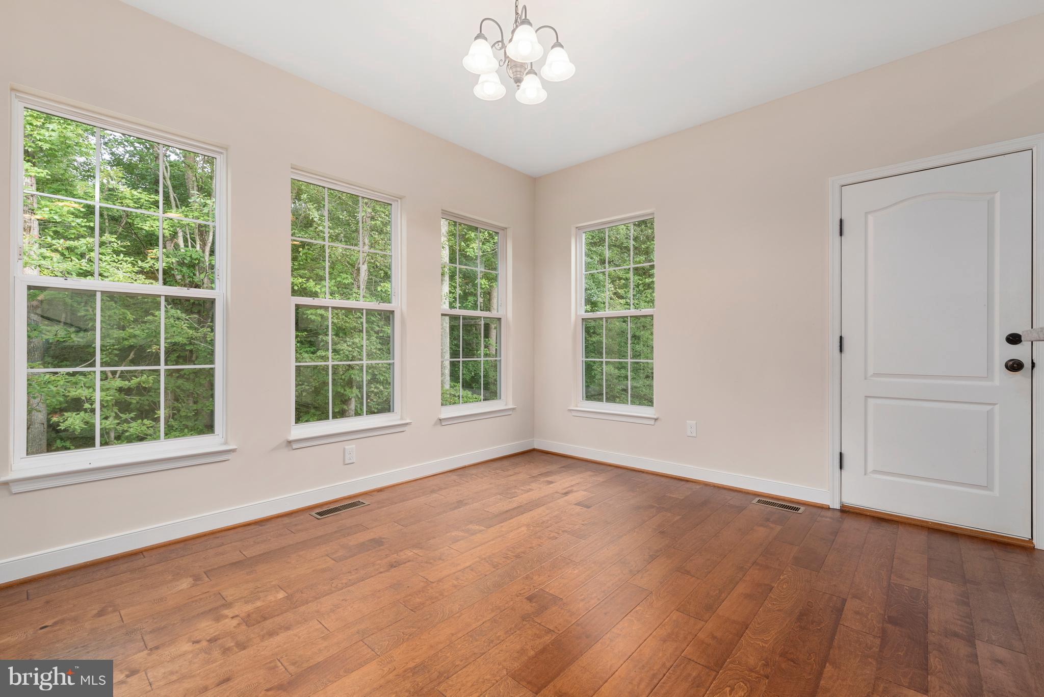 138 Sandy Ridge Road Fredericksburg, VA 22405 - Photo 8 of 30 a view of an empty room with wooden floor and a window