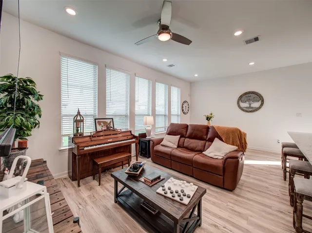 a living room with furniture fireplace and a potted plant
