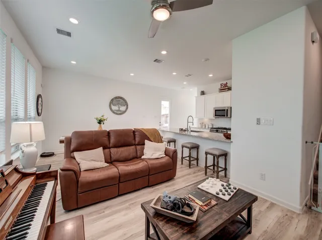 a living room with furniture and wooden floor