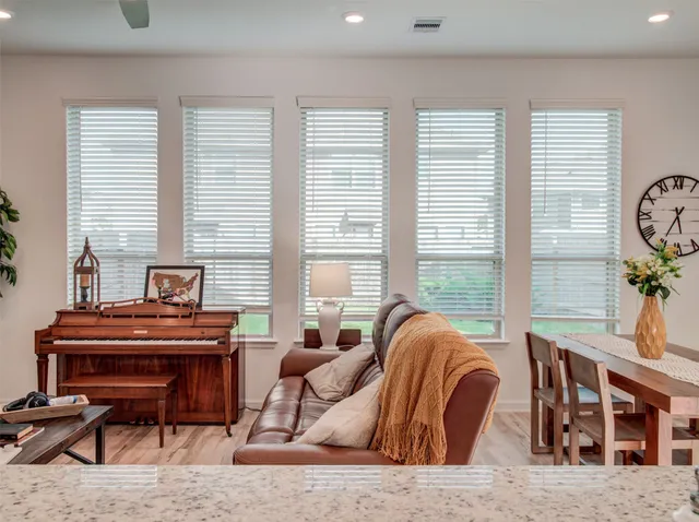 a living room with furniture and a piano