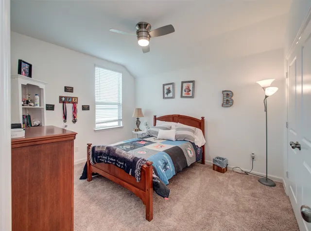 a bedroom with a bed and window