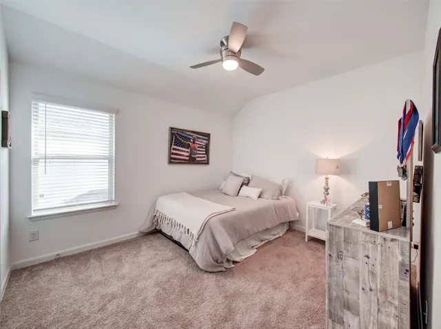 a spacious bedroom with a bed and a window