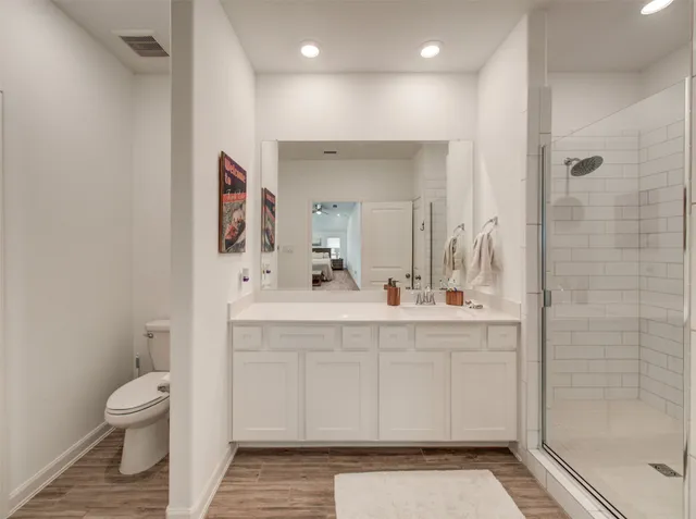 a spacious bathroom with a sink mirror and toilet