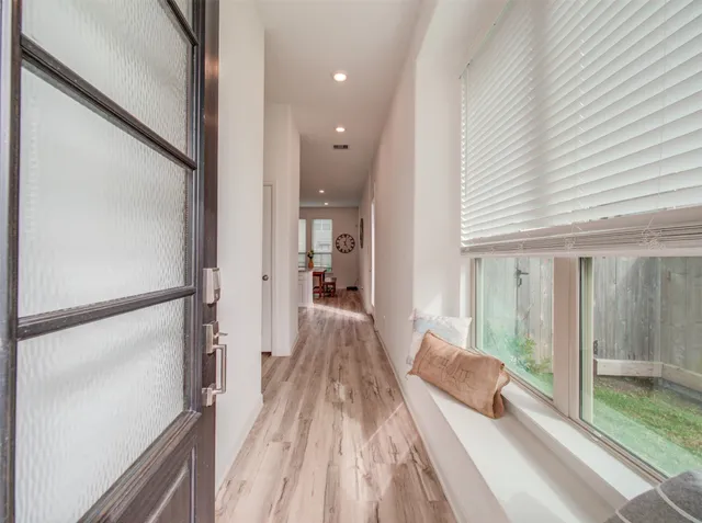 a view of a living room hardwood floor and an entryway