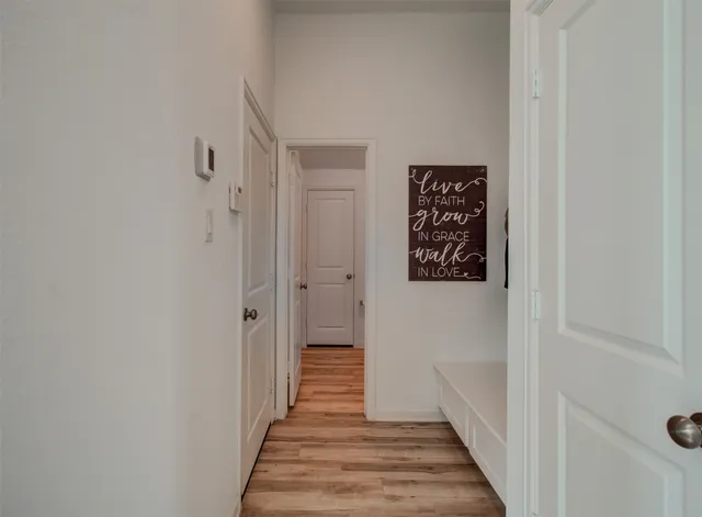 a view of a hallway with wooden floor
