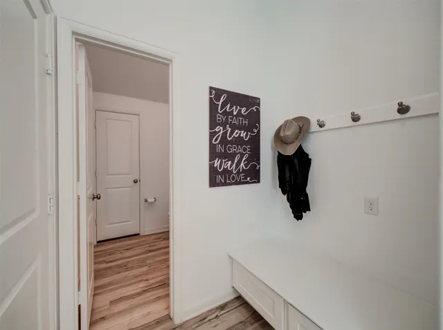 a view of a hallway with wooden floor