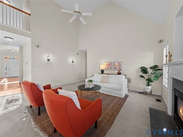 a living room with furniture a fireplace and a potted plant