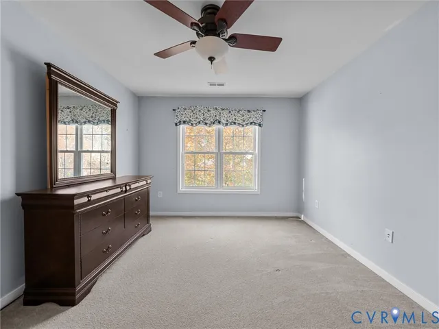 a room with a dresser and a window