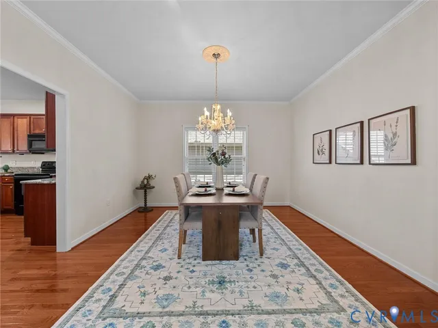 a very nice looking dining room with a table and a chandelier