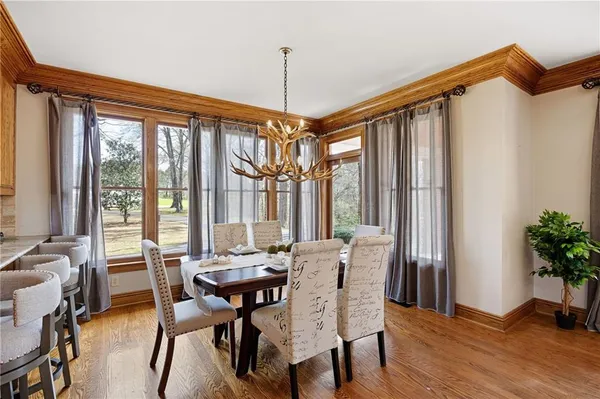 a spacious bedroom with a large bed and a chandelier