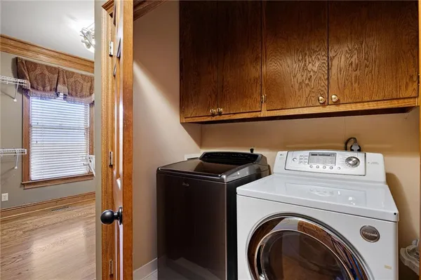 a view of a lake with a large yard and large trees