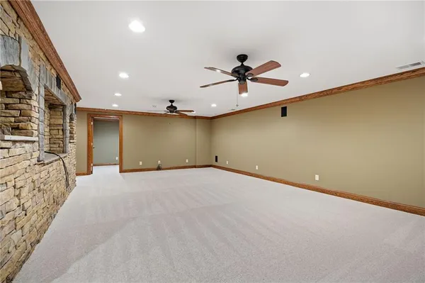 a spacious bathroom with a granite countertop toilet a sink and a mirror