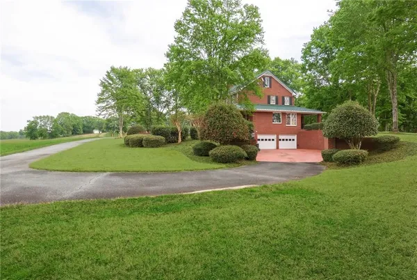 a front view of a building with garden
