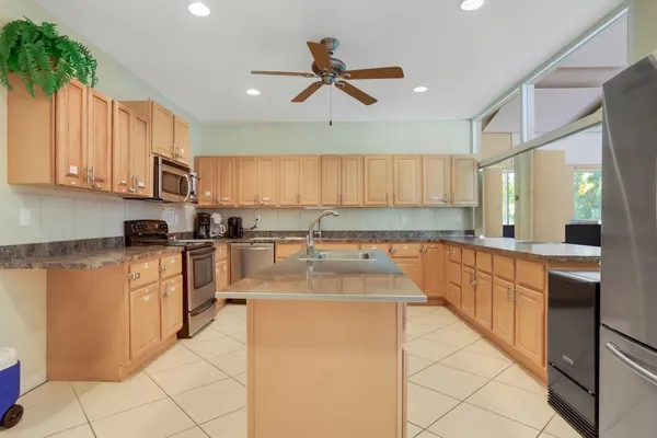 a kitchen with stainless steel appliances granite countertop a stove sink and cabinets