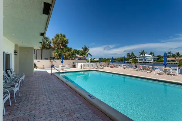 a view of a swimming pool and outdoor seating
