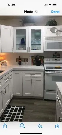 a kitchen with a sink a stove and cabinets