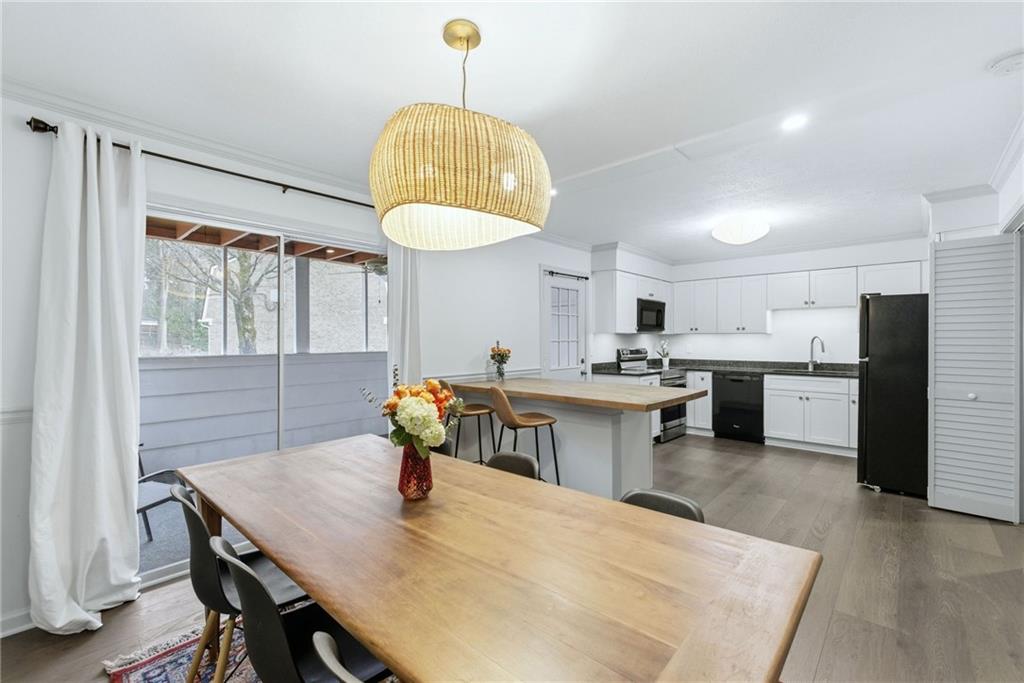 3825 Lavista Road, Unit A1 Tucker, GA 30084 - Photo 13 of 30 a kitchen with stainless steel appliances a table chairs and chandelier