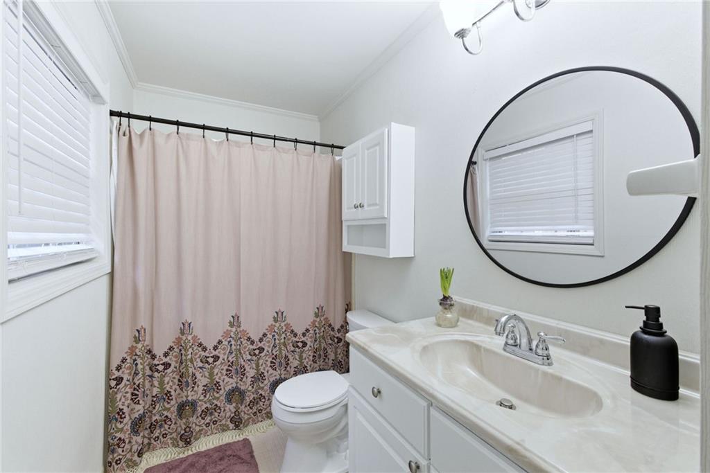 3825 Lavista Road, Unit A1 Tucker, GA 30084 - Photo 22 of 30 a bathroom with a sink mirror and toilet