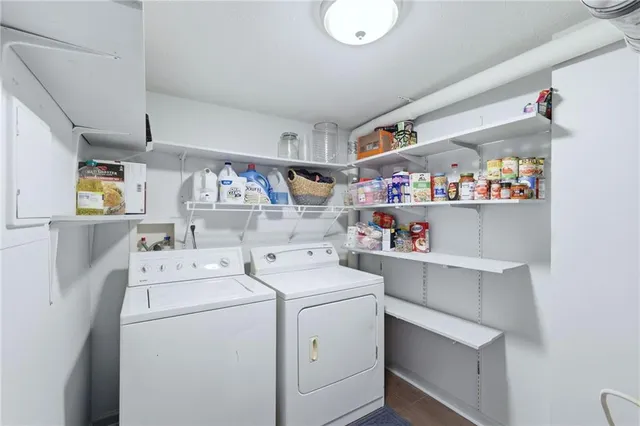 a view of storage and utility room with washer and dryer
