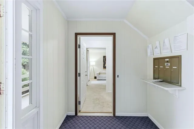 a view of a hallway with wooden floor and cabinet