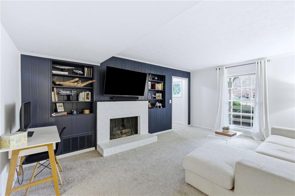 3825 Lavista Road, Unit A1 Tucker, GA 30084 - Photo 3 of 30 a living room with furniture a flat screen tv and a fireplace