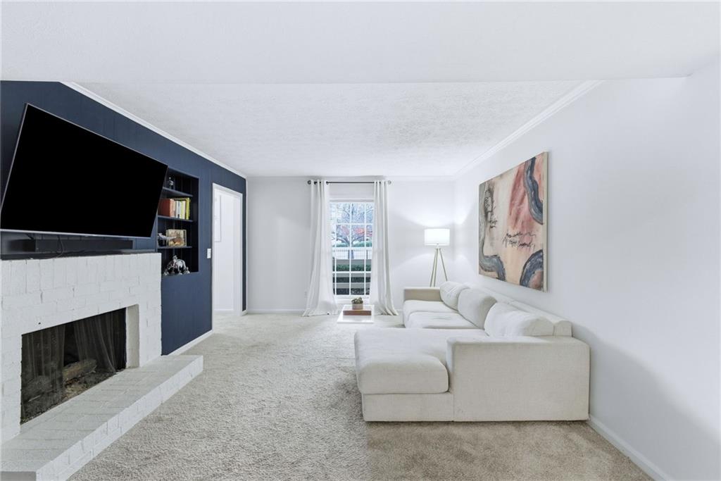 3825 Lavista Road, Unit A1 Tucker, GA 30084 - Photo 4 of 30 a living room with furniture a flat screen tv and a fireplace