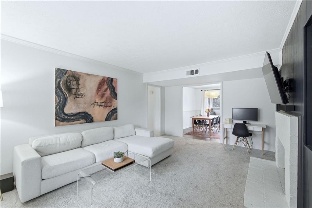 3825 Lavista Road, Unit A1 Tucker, GA 30084 - Photo 5 of 30 a living room with furniture and a flat screen tv