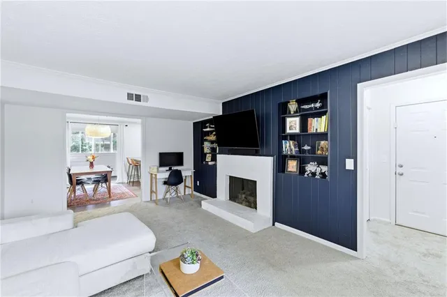 a living room with furniture a fireplace and a flat screen tv