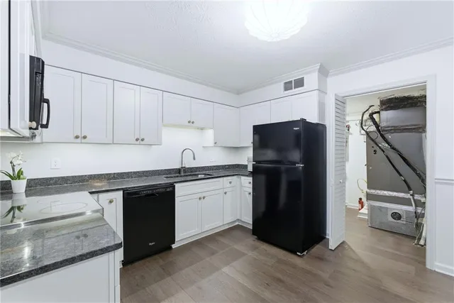 a kitchen with stainless steel appliances granite countertop a refrigerator and a sink